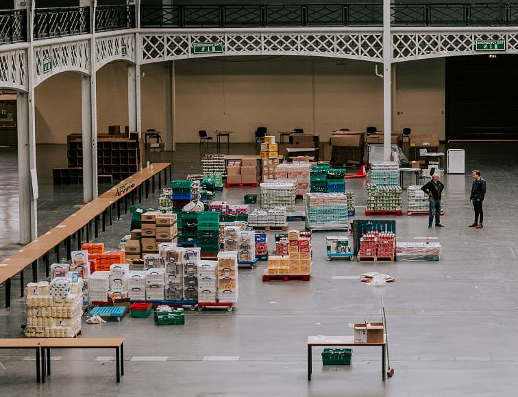 Bankuet food distribution warehouse with volunteers organizing supplies