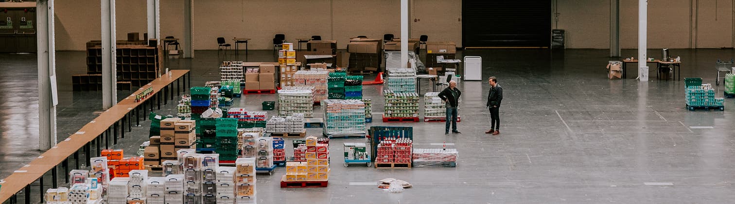 Bankuet food distribution warehouse with volunteers organizing supplies